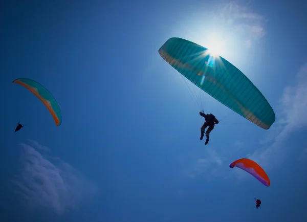Paragliders soaring in a blue sky Royalty Free Stock Photos