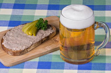Bread with liverwurst and a glass of beer clipart