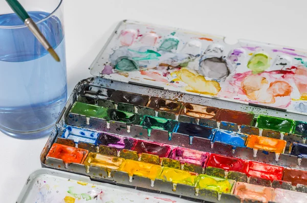 Watercolors with brush and water glass — Stock Photo, Image