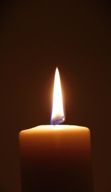 Burning candle, vertical orientation. clipart