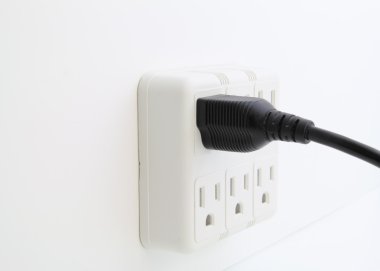 Power cord plugged into wall outlet. clipart