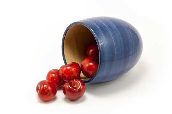 Juicy ruby red cherries in a blue cup — Stock Photo, Image