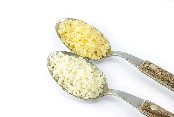 Two varieties of rice in two tablespoons — Stock Photo, Image