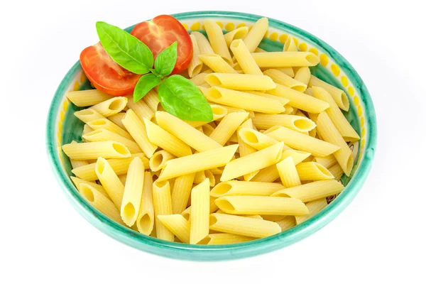 Bowl full of pens pasta with tomatoes and basil — Stock Photo, Image