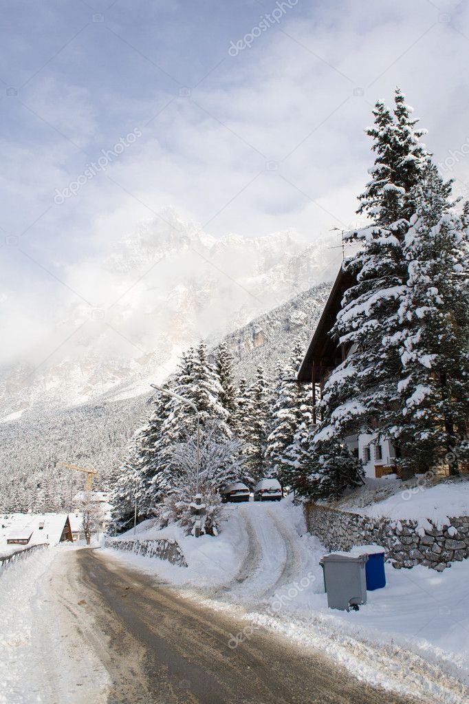 A snow-covered road in the shadow of the Dolomites near Cortina