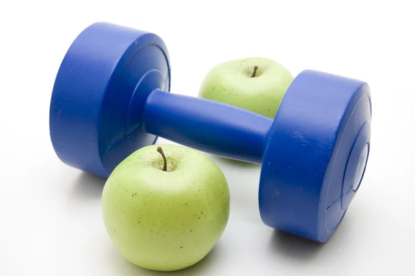 Blue dumbbells with apple — Stock Photo, Image