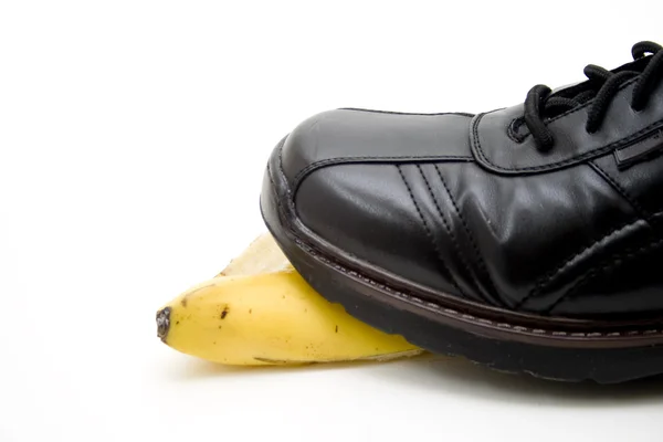 stock image Men shoe steps on banana peel