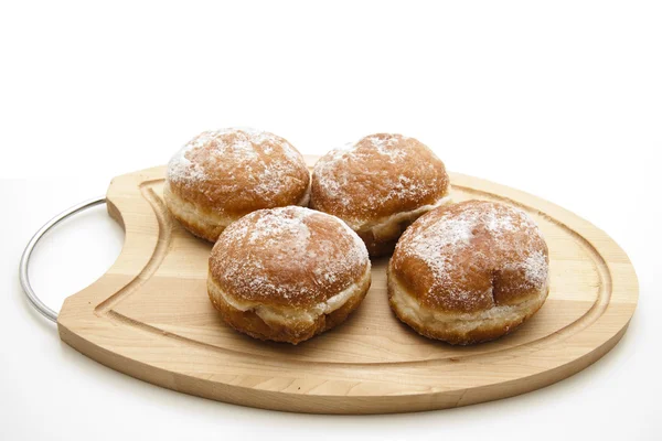 Donuts on wooden plate — Stock Fotó