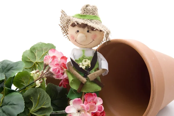 Geraniums with straw doll — Stock Photo, Image