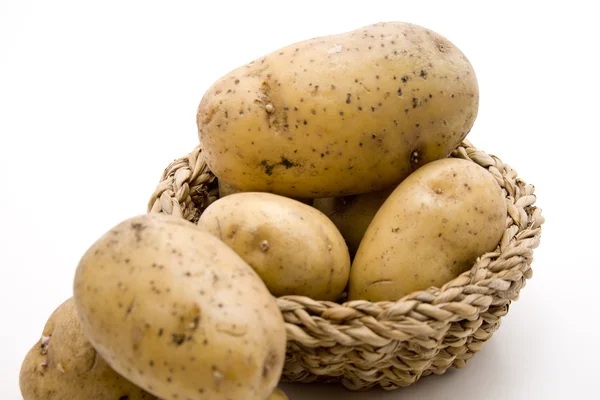 Raw potatoes in the basket — Stock Photo, Image
