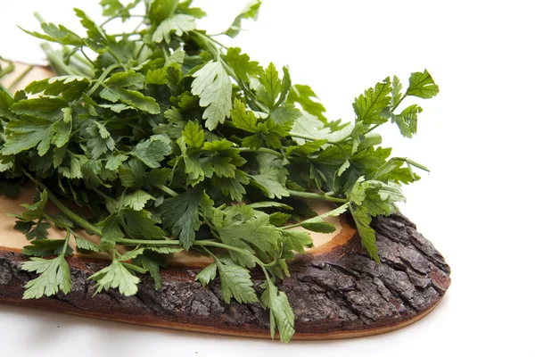 Parsley wooden plate with bark — Stock Photo, Image