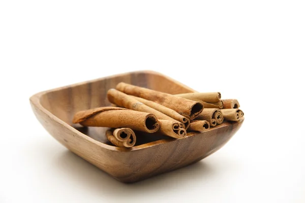 Cinnamon sticks in wooden bowl — Stock Photo, Image