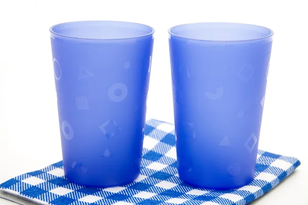 Stock image Drinking mugs on checked napkin