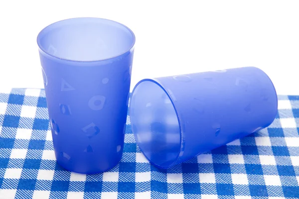Drinking mugs on checked napkin — Stock Photo, Image