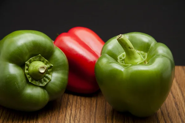Green and red pepper on table — Stock Photo, Image