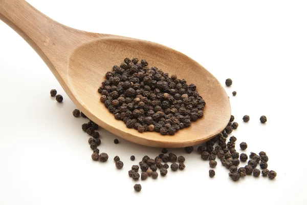 Peppercorn on wooden spoon — Stock Photo, Image