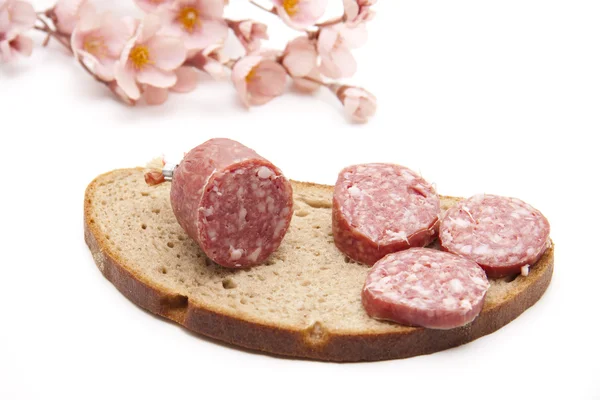 Garlic salami slivered on bread — Stock Photo, Image