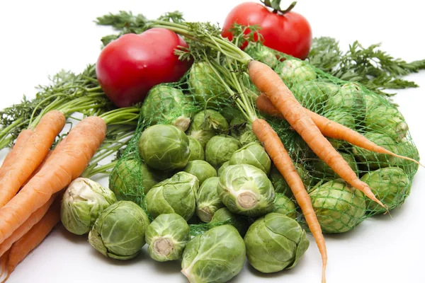 Brussels sprouts and carrots with tomato — Stock Photo, Image