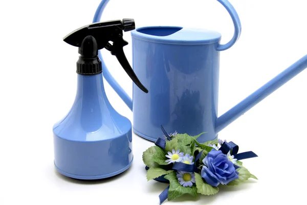 Blue spray bottle and watering can — Stock Photo, Image