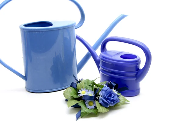 Blue spray bottle and watering can — Stock Photo, Image