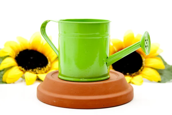Gieter met zonnebloemen — Stockfoto