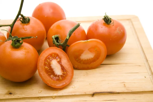 Świeże pomidory na drewnianej desce — Zdjęcie stockowe