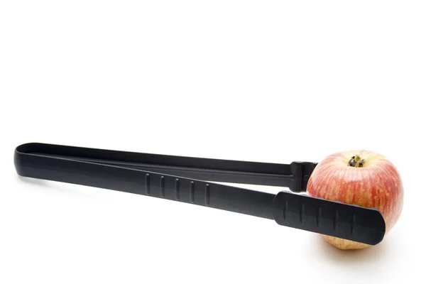 stock image Apple with grill tongs