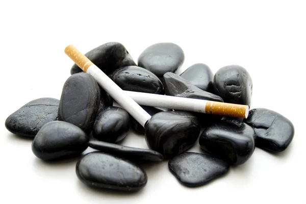 Black stones with cigarette — Stock Photo, Image