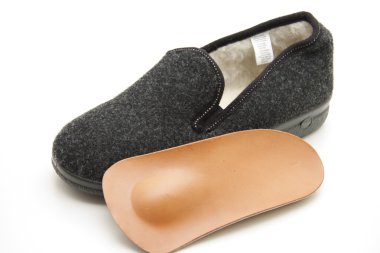 Slipper with orthopaedic arch support clipart