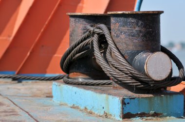 Winch with metal cable on a cargo ship. clipart