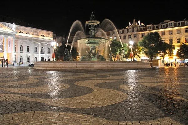 stock image Fountain at the central place Rossio by night (Lisbon)