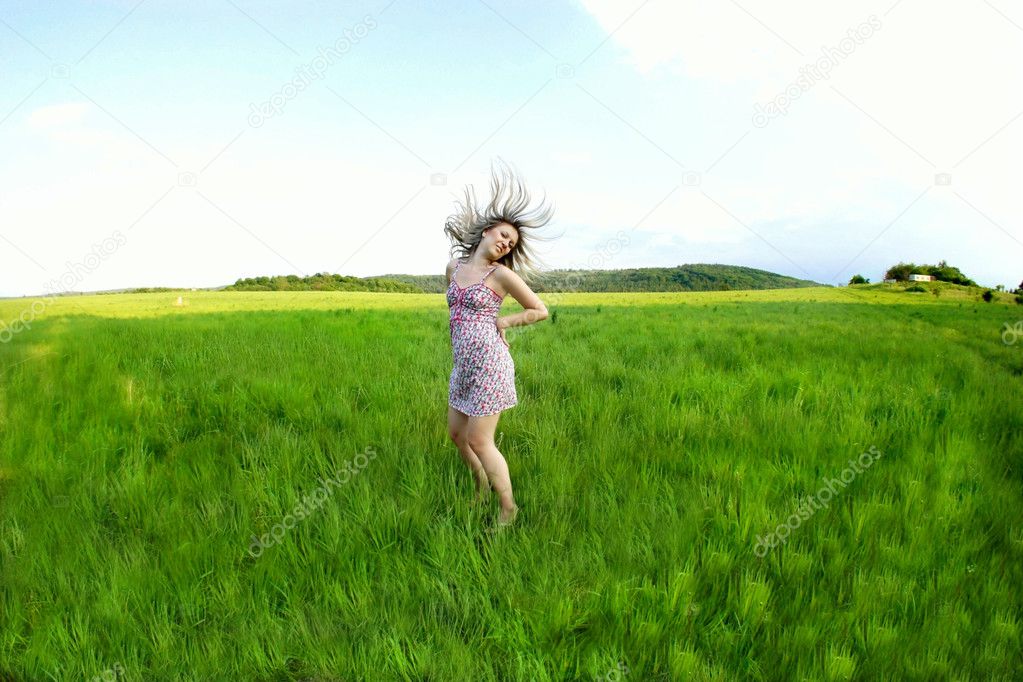 Young woman and green fields