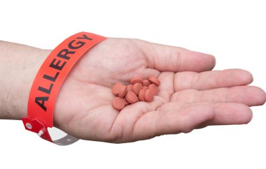 Hand With Allergy Wrist Band And Medicine clipart