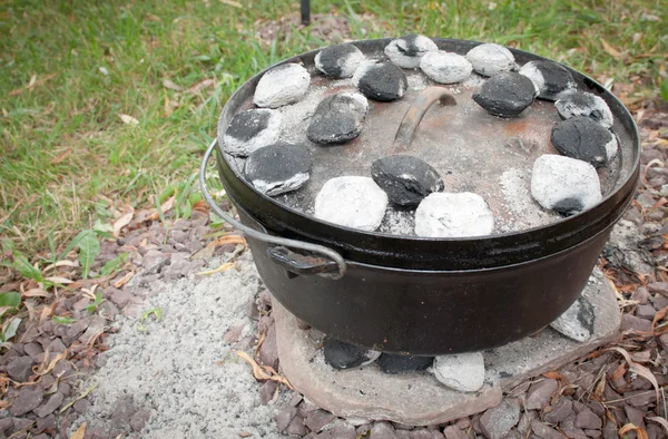 Coals on the Lid of a Dutch Oven Cooking Dinner Stock Image