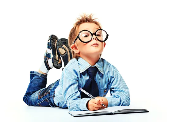 stock image boy in spectacles and suit lying on a floor