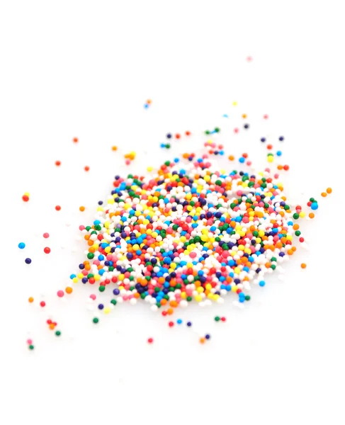 Colorful sprinkles on white background — Stock Photo, Image