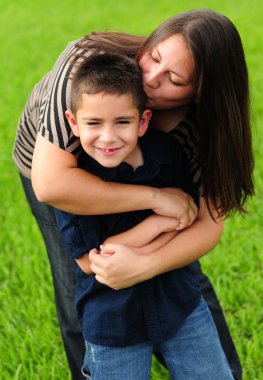 Mommy kissing son clipart