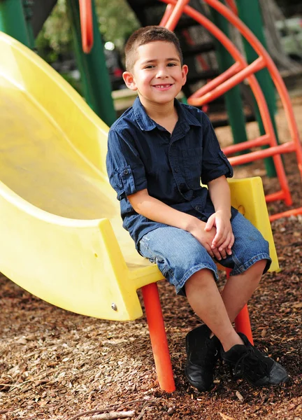 Happy young child and slide — Stock Photo, Image