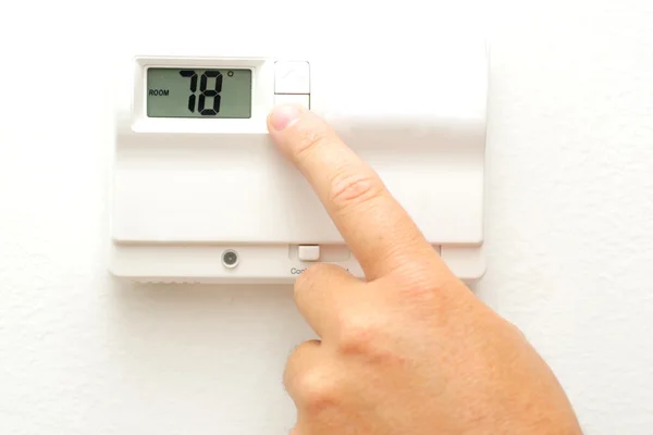 Hand and thermostat — Stock Photo, Image