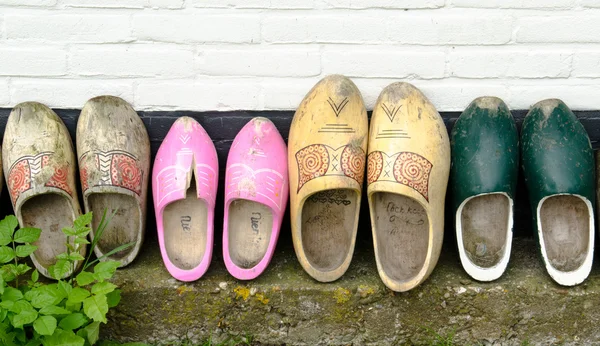 Stock image Wooden shoes against a wall