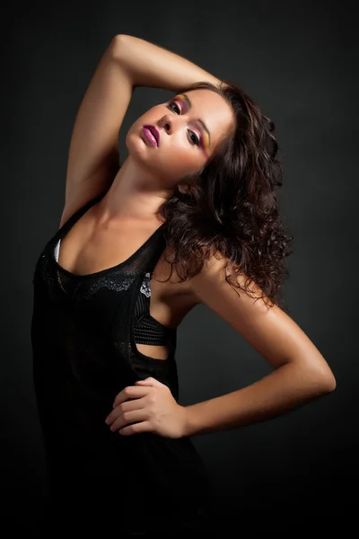 Elegant young woman on dark background — Stock Photo, Image