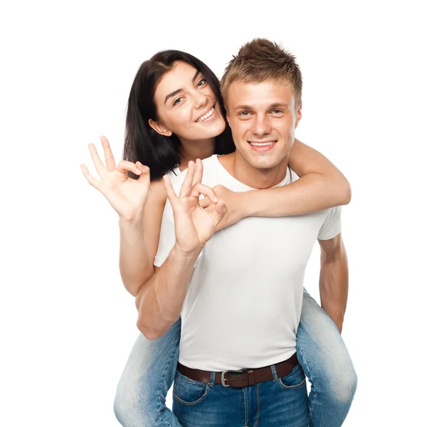 Happy young couple doing Ok gesture — Stock Photo, Image