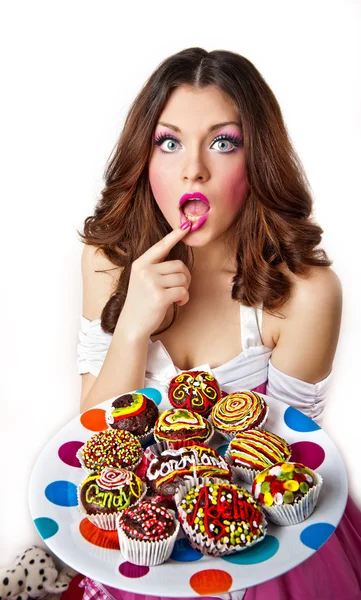 Pretty woman eating cakes. Isolated on the white background — Stock Photo, Image