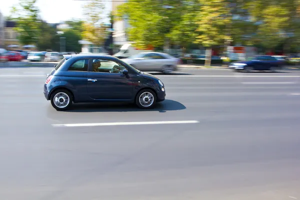 Small car running on the street Stock Photo