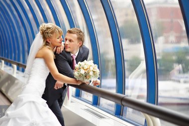 Bride and groom in interiors of Bridge Business Center clipart