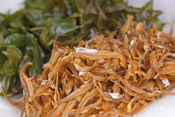 Fried Asian Anchovies with Fried Curry Leaves in the Background — Stock Photo, Image