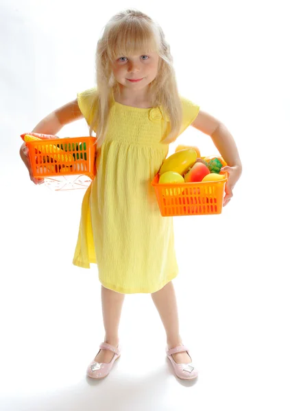 stock image The girl with two containers for toys