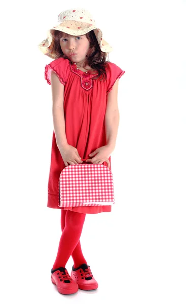 Здивована дівчина з червоною маленькою валізою — стокове фото