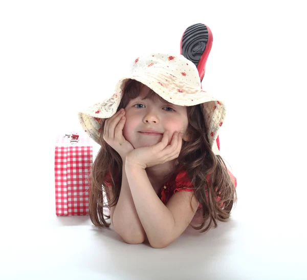 The little girl lies in a hat — Stock Photo, Image