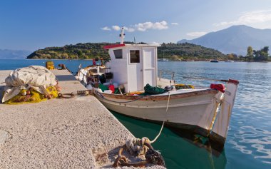 Traditional Greek fishing boat at Archaia Epidaurus harbor, Greece clipart